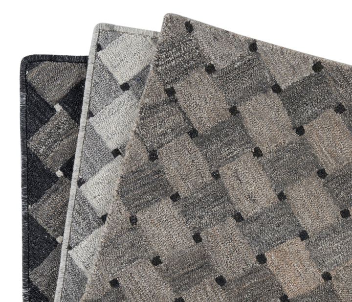 Three carpet samples in grays and blacks overlap, showcasing textures.