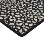 Close-up of two-toned geometric lattice rug with plush texture.