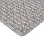 Close-up of durable rug with alternating colors, raised tufts.