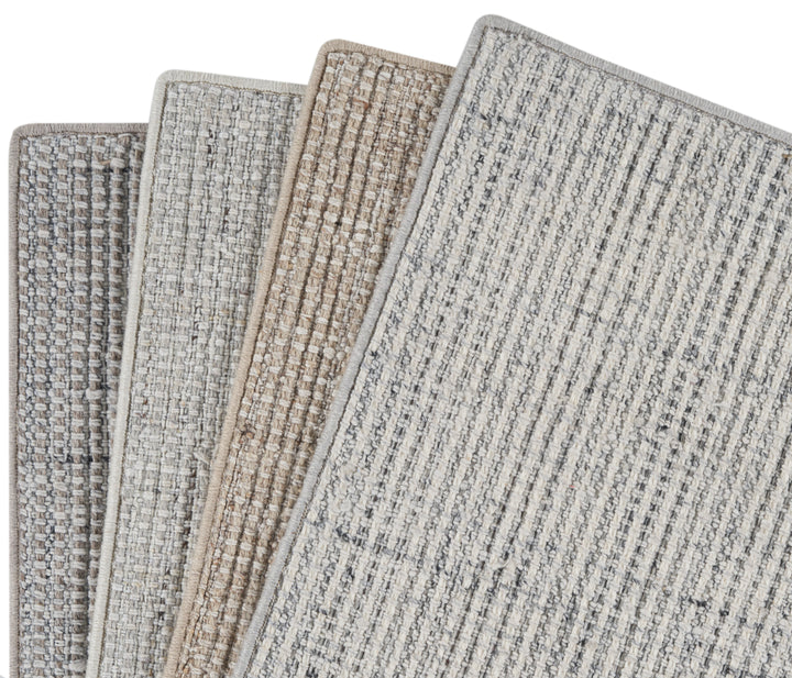 Neutral fabric swatches and carpet samples for interior design projects.