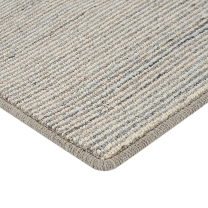 Close-up of durable loop pile rug in neutral striped pattern.