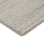 Close-up of durable loop pile rug in neutral striped pattern.