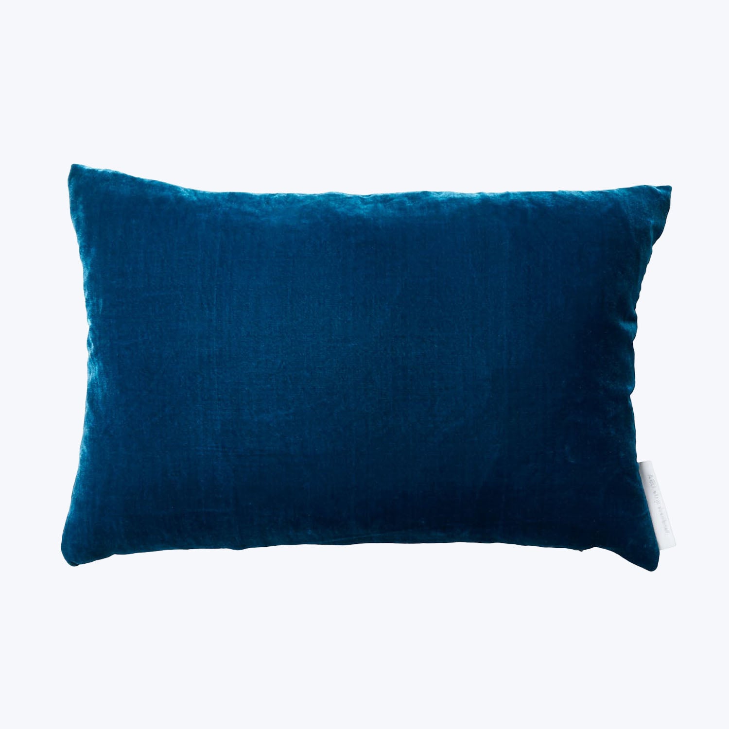 Rectangular deep blue velvet pillow with plush texture on white background.