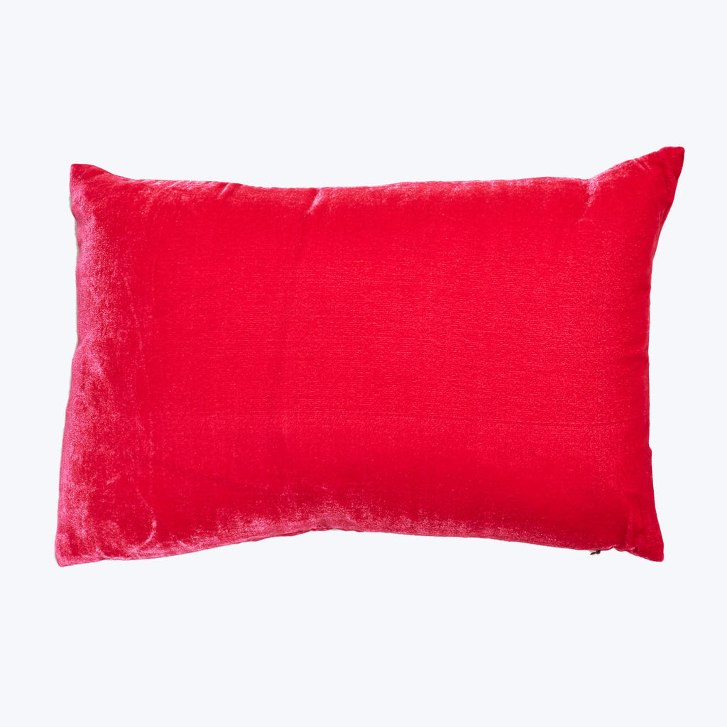 A luxurious red velvet pillow on a clean white backdrop.