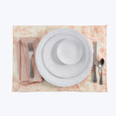 Neatly set formal dining table with elegant tablecloth and utensils