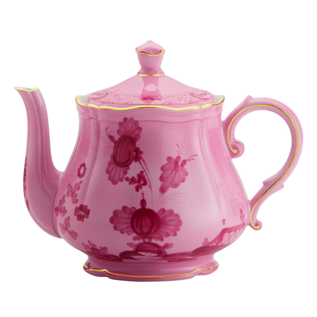 Pink teapot with floral design, gold trim, and elegant aesthetic.