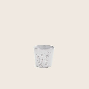 Rustic cup with plant relief design in light gray color.