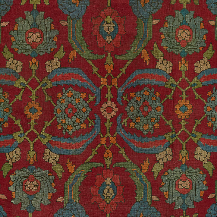 Symmetrical, ornamental carpet design with stylized floral motifs and vibrant colors.