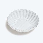 Scallop shell shaped dish with ridged pattern, glossy finish, decorative.