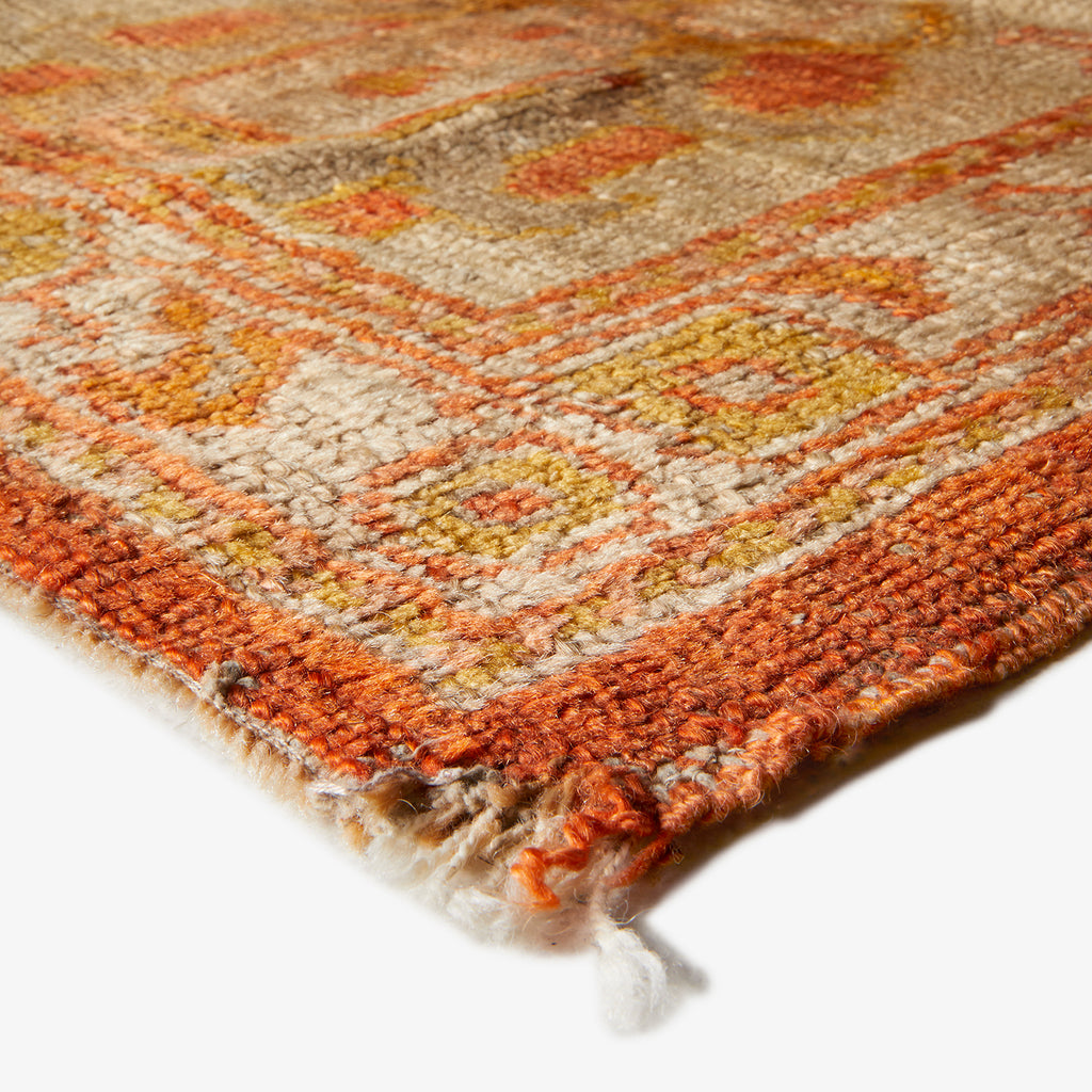Close-up of a handwoven rug featuring earthy tones and textured weave.