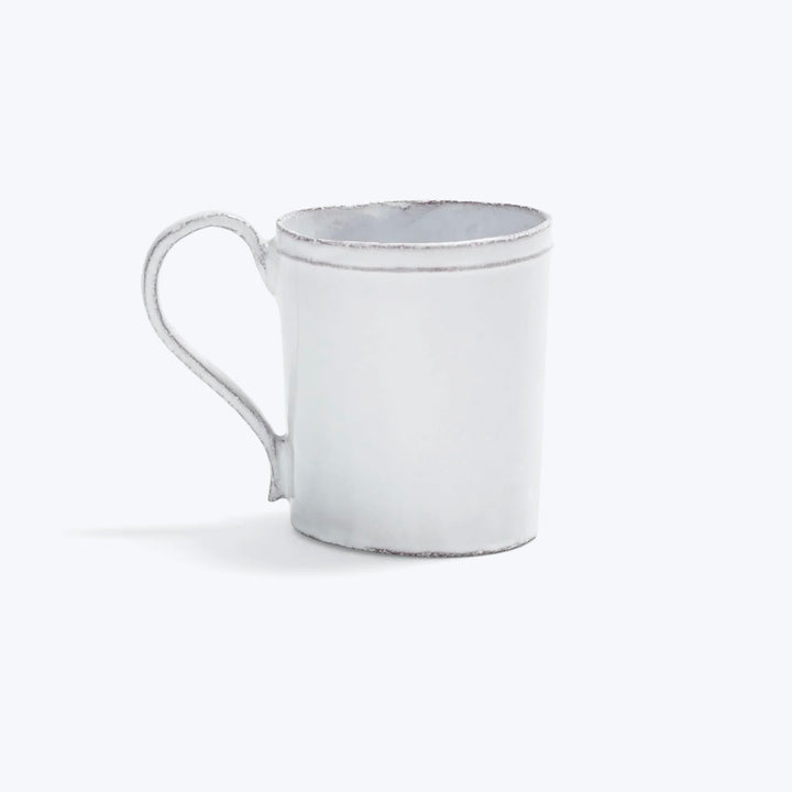 White distressed mug with simple handle on minimalistic background.