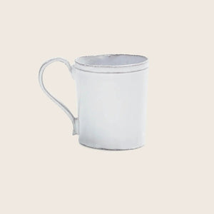 White distressed mug with simple handle on minimalistic background.