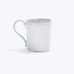White distressed mug with simple handle on minimalistic background.