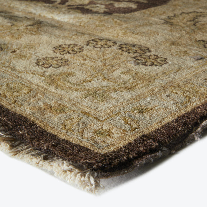 Folded handwoven rug showcasing rich earthy tones and intricate pattern.