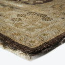 Folded handwoven rug showcasing rich earthy tones and intricate pattern.