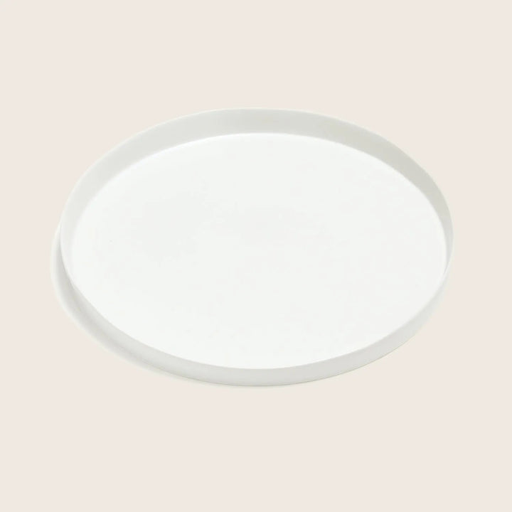 Plain white plate with a subtle shadow against white background.