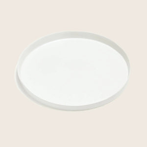 Plain white ceramic plate with raised edge on light background. - hover