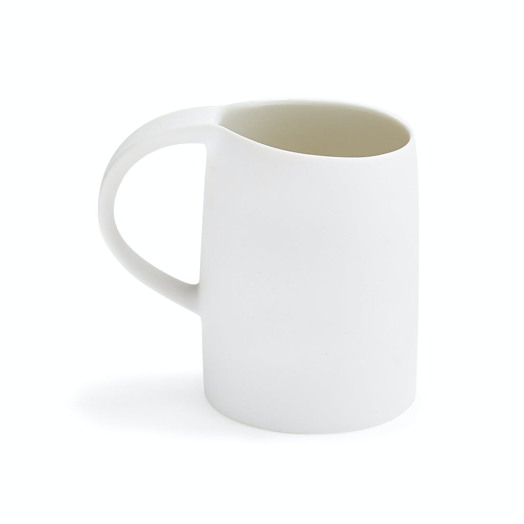 Minimalist white mug with sleek design and ergonomic handle.