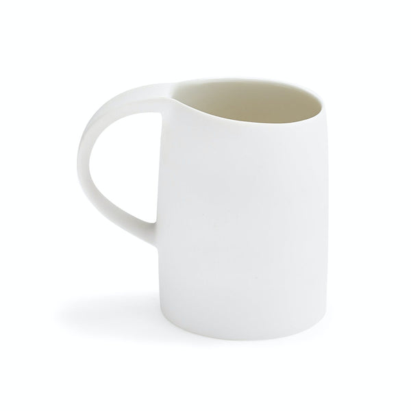 Minimalist white mug with sleek design and ergonomic handle.