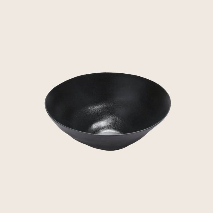 Modern black bowl with a smooth, reflective surface and minimalist design.
