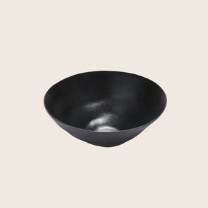 Modern black bowl with a smooth, reflective surface and minimalist design.