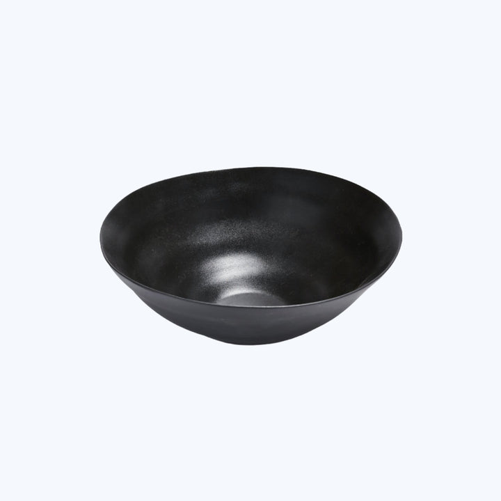Minimalist black bowl with matte finish on white background.