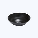 Minimalist black bowl with matte finish on white background.