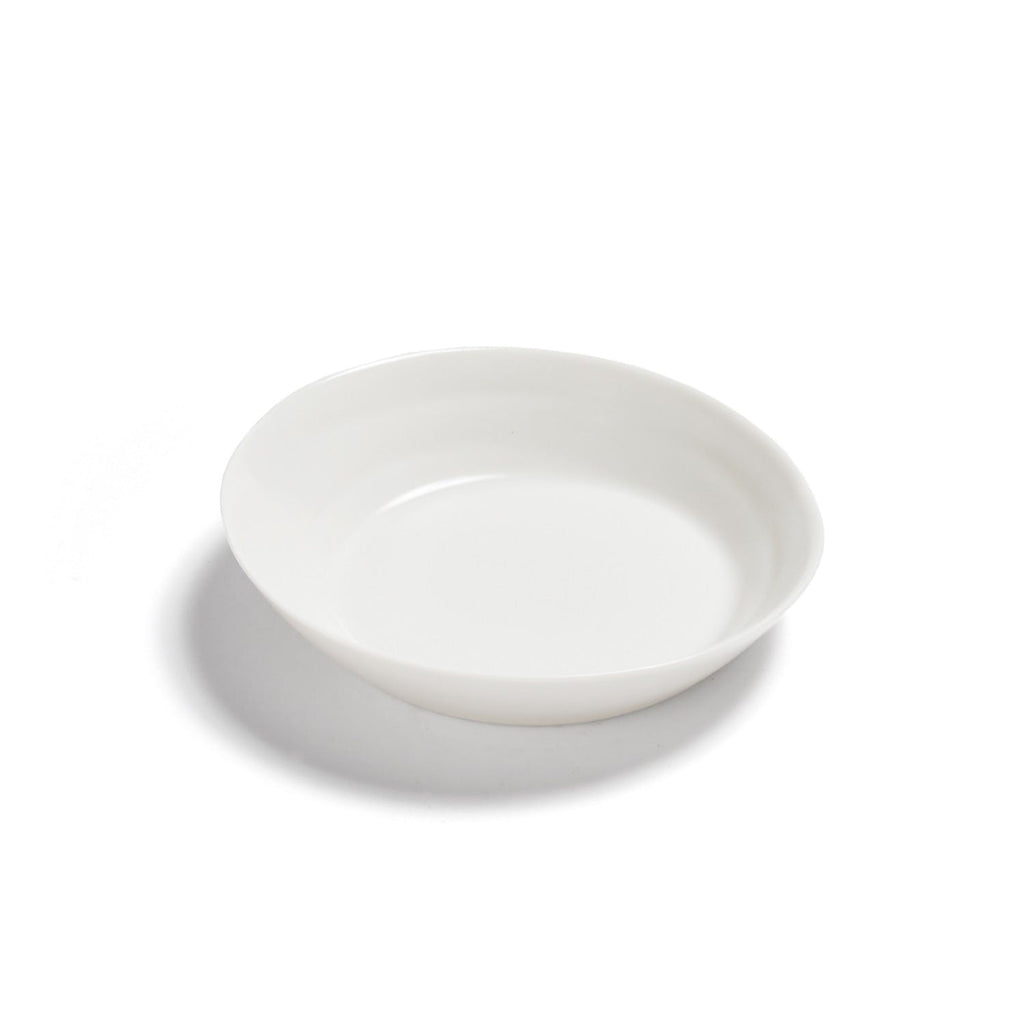 A clean and minimalistic white plate on a plain background.