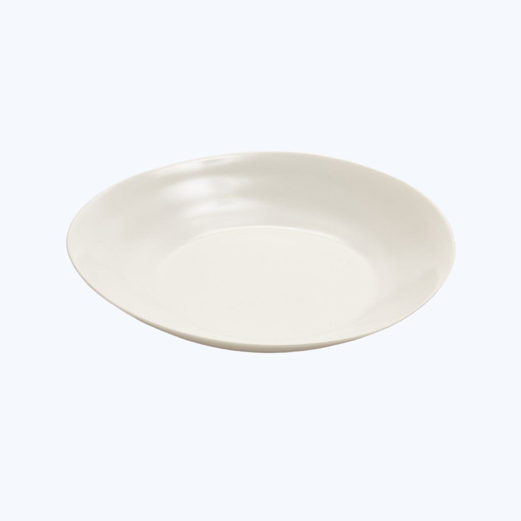 Minimalistic white plate with a gentle curved rim on neutral background.