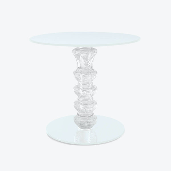 Minimalist glass table with frosted top and elegant sculpted base.
