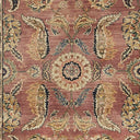 Intricate handwoven rug displays detailed floral and foliate pattern design.
