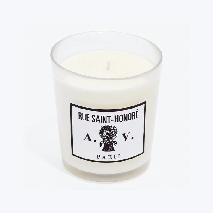 Luxurious scented candle in glass container with chic French label.
