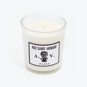 Luxurious scented candle in glass container with chic French label.