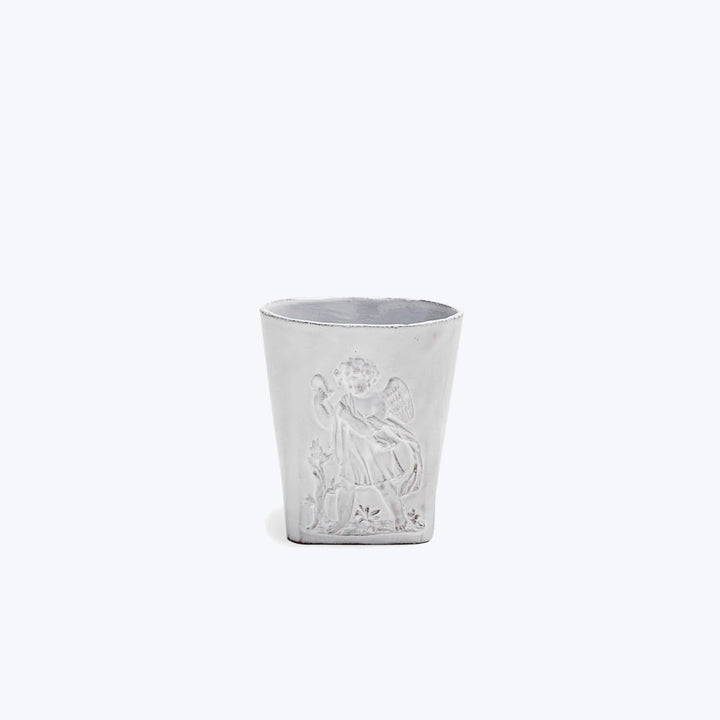 Embossed white cup with angelic figure design and floral patterns.