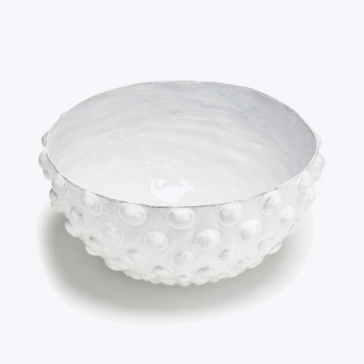 Textured white ceramic bowl with raised bumps and shiny glaze.