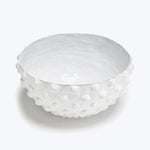 Textured white ceramic bowl with raised bumps and shiny glaze.