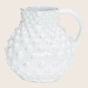White ceramic pitcher with raised spherical bumps and textured surface