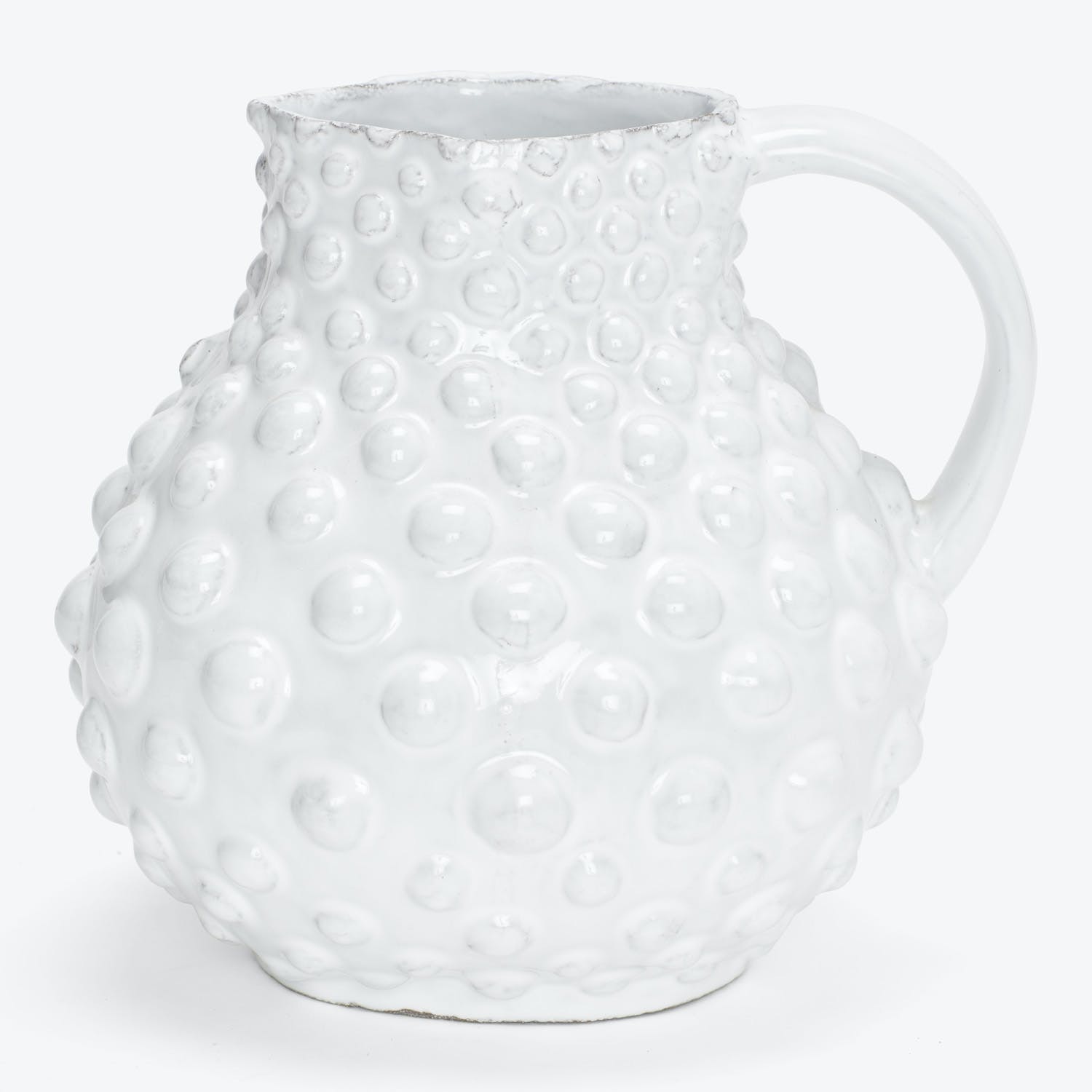 White ceramic pitcher with raised spherical bumps and textured surface