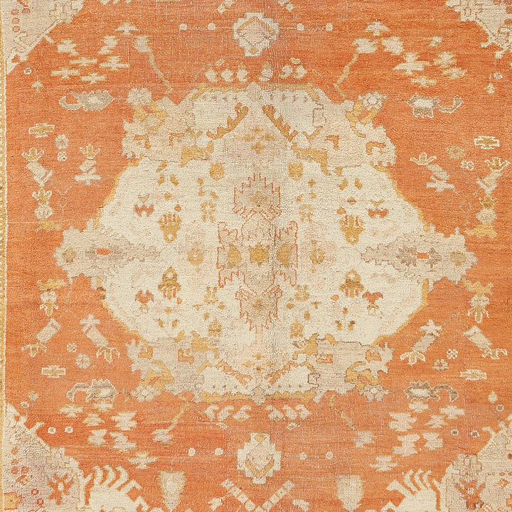 Intricate symmetrical rug with vintage vibes in orange and beige.