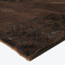 Ornate brown rug with plush texture and intricate black patterns