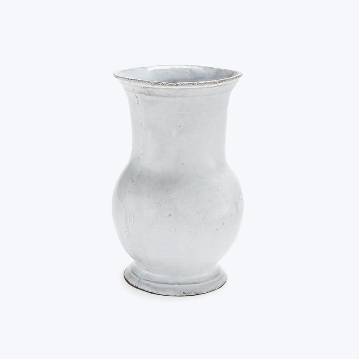 Glass vase with frosted finish, traditional shape against bright backdrop.