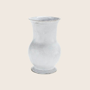 Glass vase with frosted finish, traditional shape against bright backdrop.