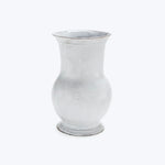 Glass vase with frosted finish, traditional shape against bright backdrop.