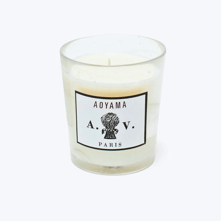 Scented candle with AOYAMA label and elegant design in glass.