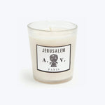 White scented candle in chic Jerusalem-themed glass container, unlit wick.