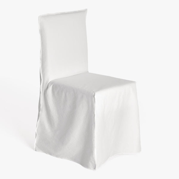 Minimalistic white slipcovered chair showcased in a well-lit setting.
