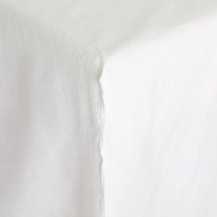 Close-up of white fabric revealing soft folds and subtle textures.