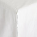 Close-up of white fabric revealing soft folds and subtle textures.