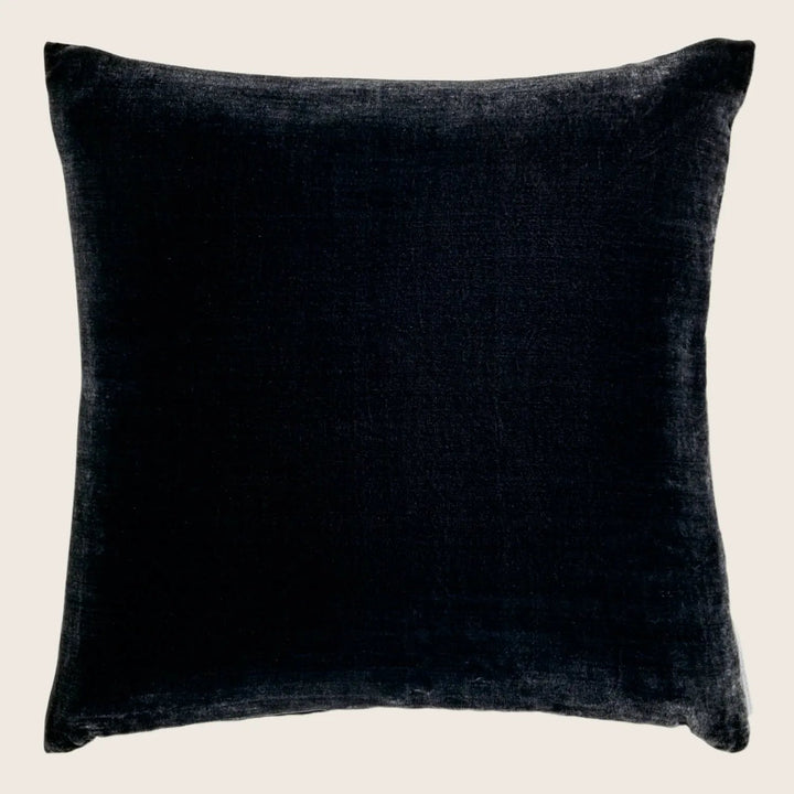 Stylish navy velvet pillow with contrasting white background.
