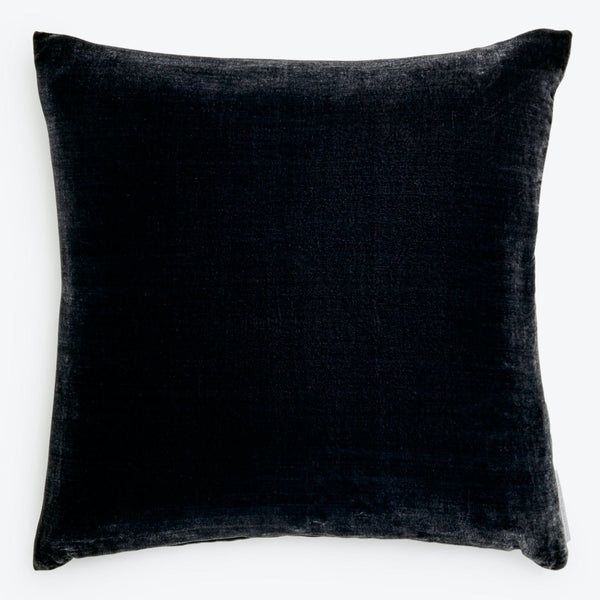 Stylish navy velvet pillow with contrasting white background.